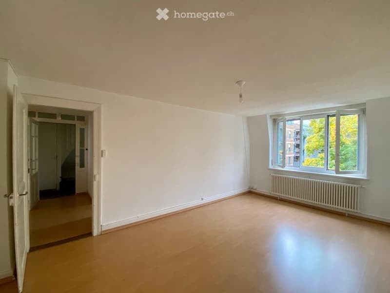 empty room, wooden floor, white walls, large window, radiator, open door