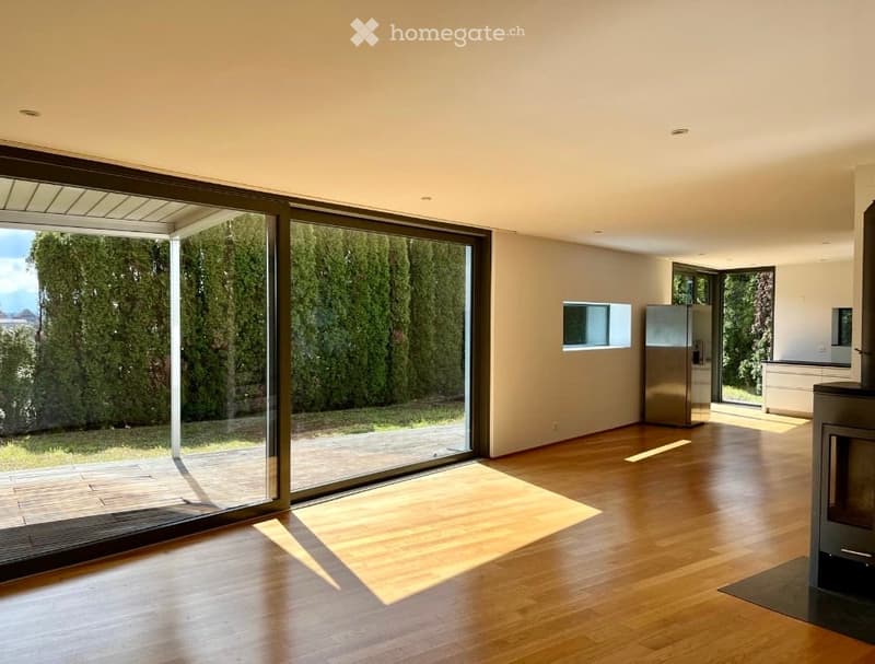 large windows, wooden floor, sliding glass doors, fireplace, stainless steel refrigerator