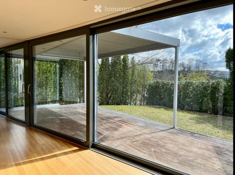 wooden floor, large sliding glass doors, wooden deck, green lawn, trees