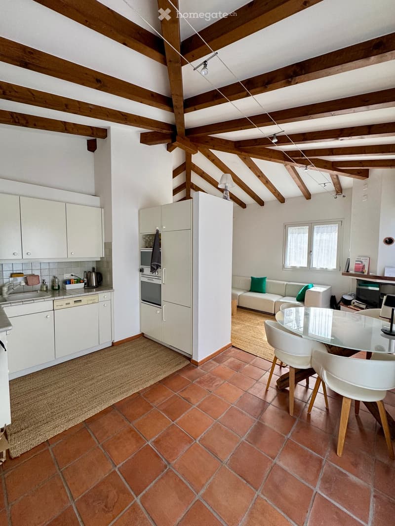 kitchen with white cabinets, terracotta tiles, wooden beams, white dining table, white chairs, white couch, fireplace