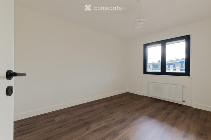 empty room, white walls, wooden floor, window, radiator