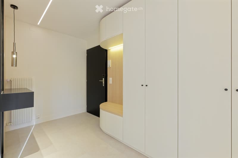 modern interior, white walls, white cabinets, black door, wooden bench, white tiled floor, pendant light