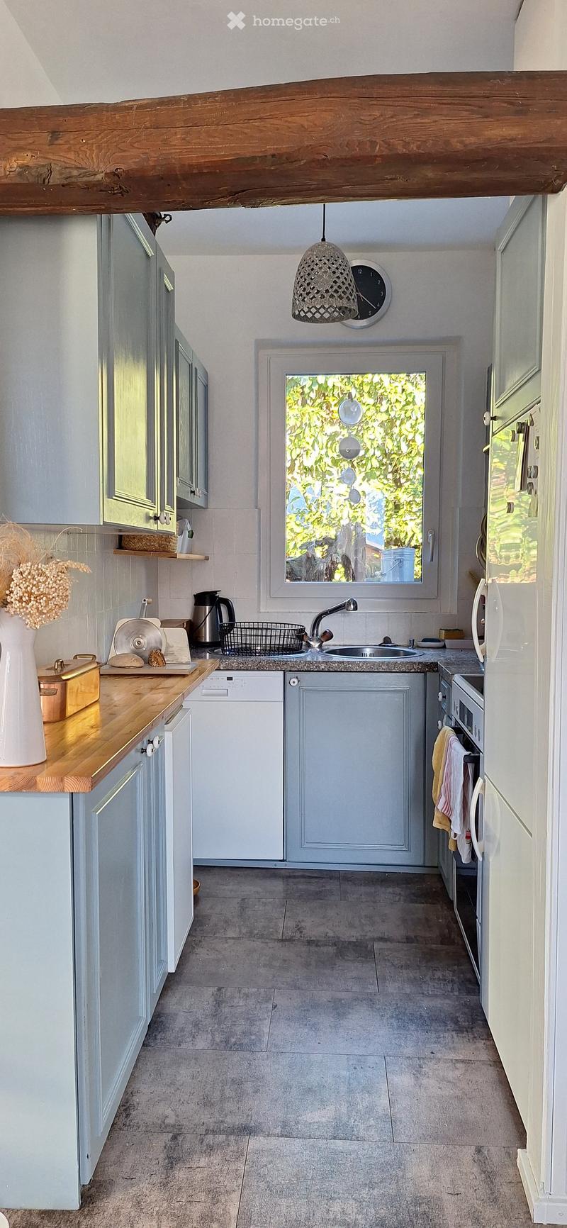 modern kitchen with wooden countertops, gray cabinets, white appliances, sink, dishwasher, washing machine, window with view of trees