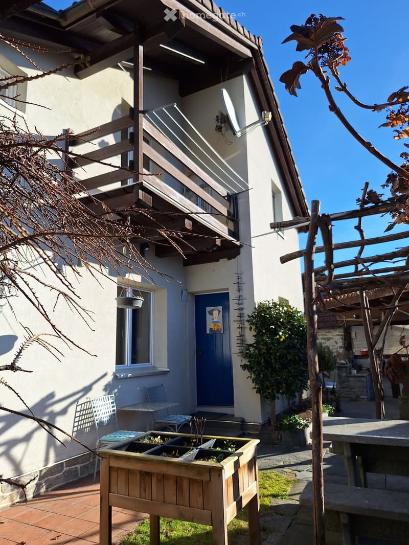 white house, blue door, balcony, outdoor seating, garden, plants