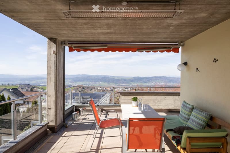 Balcony with table and chairs, sofa, potted plant, glass railing, view of the landscape