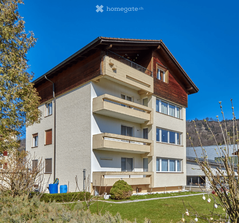 5 story building, balconies, windows, garden, trees