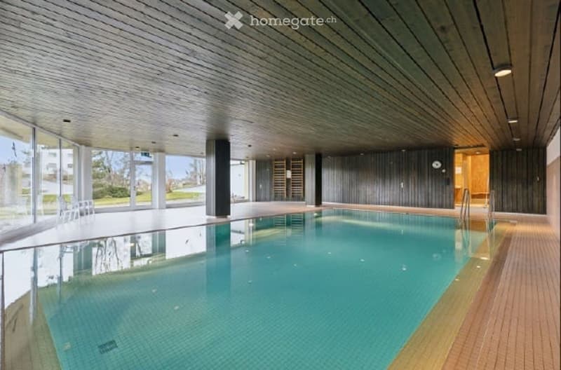 Indoor swimming pool, wooden ceiling, glass walls, wooden floor