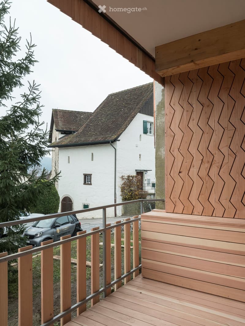 wooden floor, wooden railing, wooden wall, view of a house and car