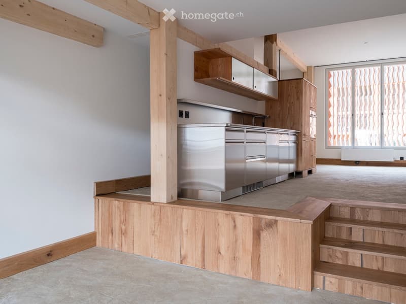 modern kitchen with stainless steel appliances, wooden cabinets, wooden flooring, white walls, large window