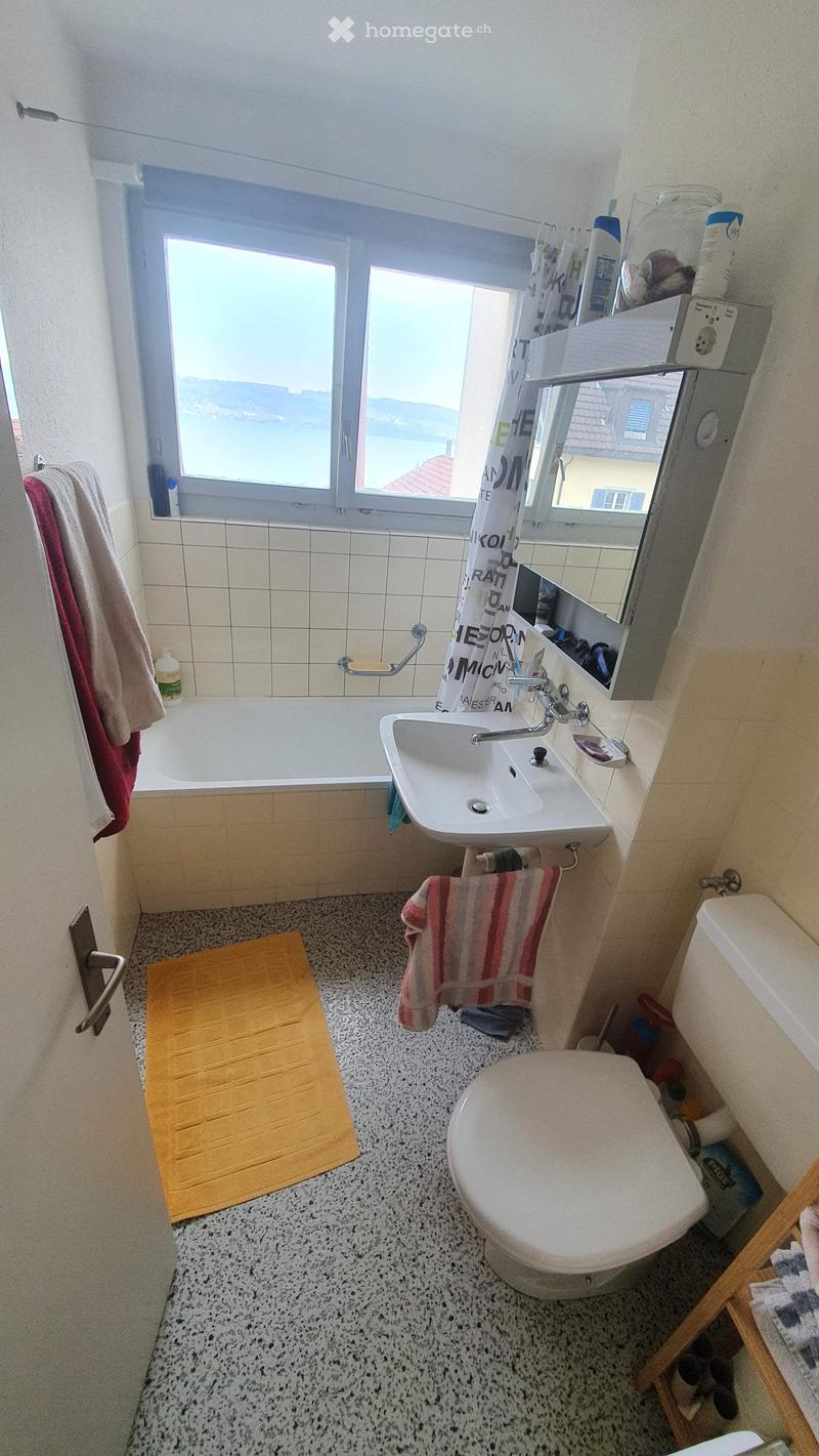 Bathtub, sink, toilet, towel racks, window with sea view
