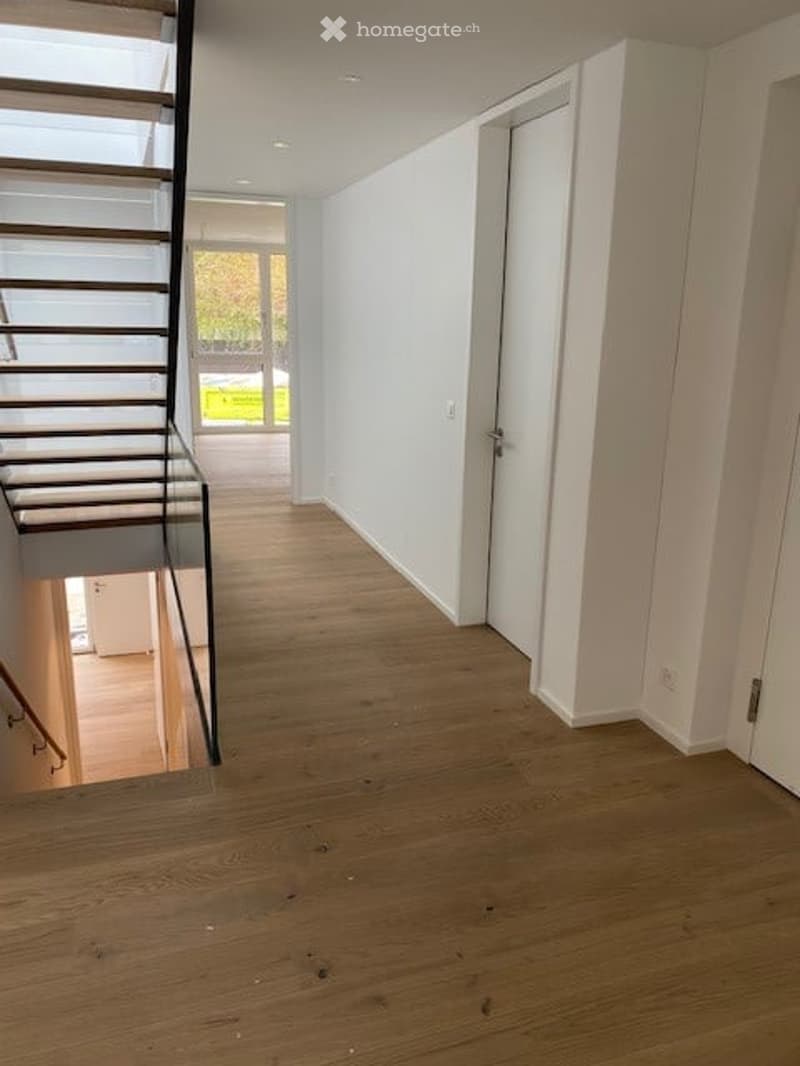Empty room, wooden floor, white walls, glass staircase, glass door, glass window