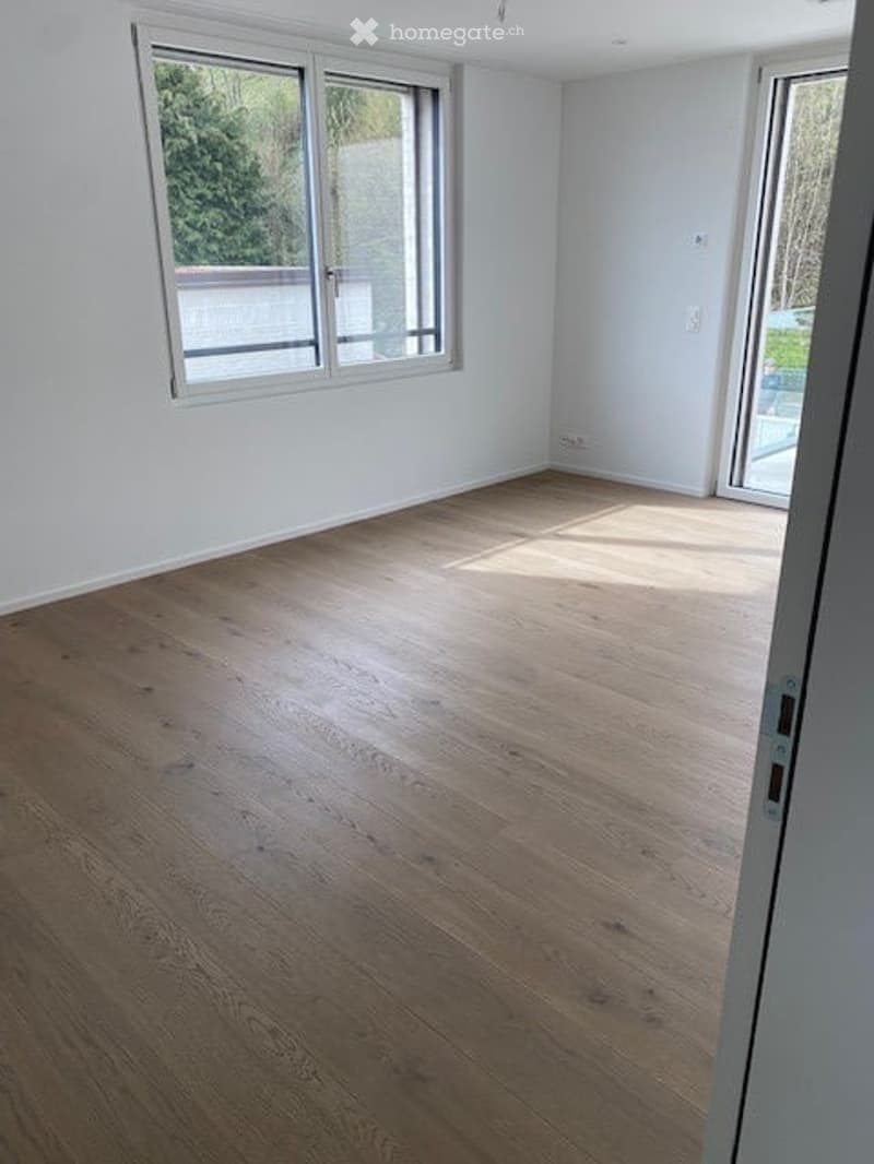 empty room, wooden floor, white walls, large windows, balcony, view of trees