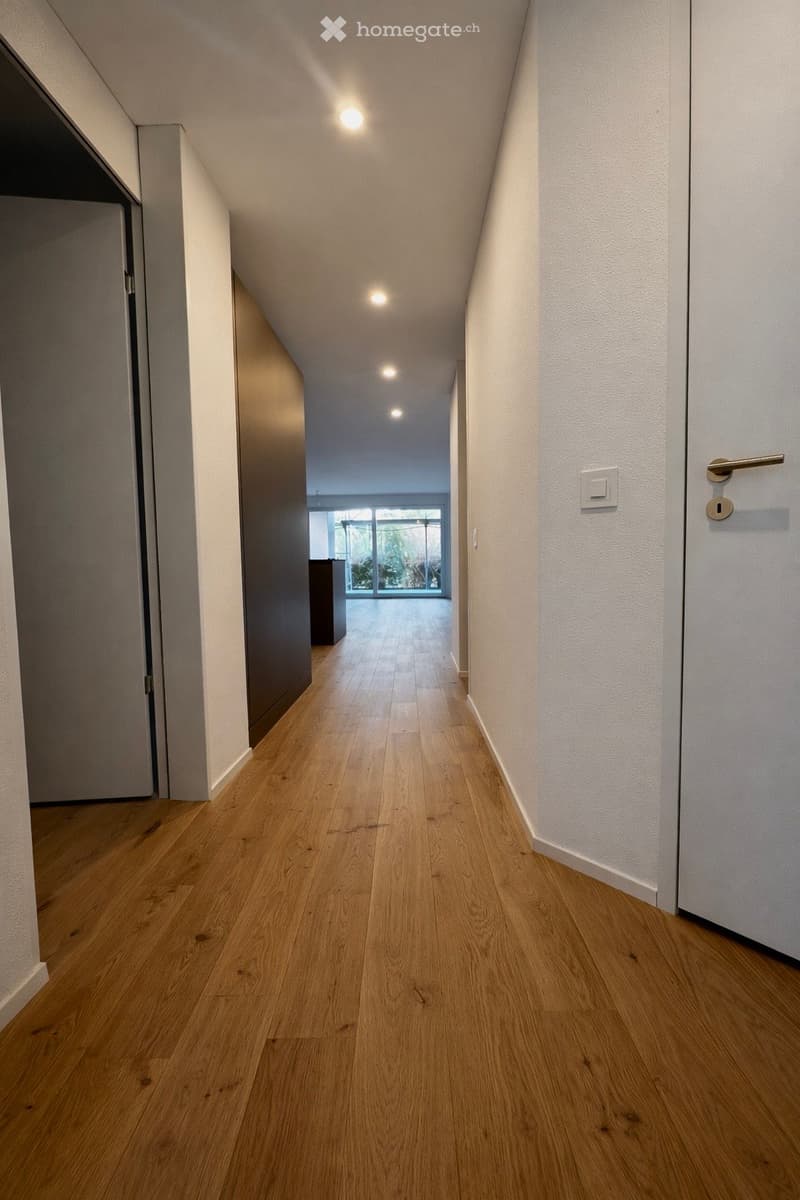 wooden floor, white walls, recessed lighting, glass windows, open door
