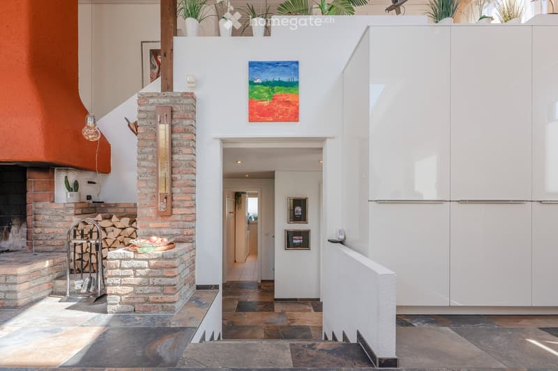 Fireplace, brick wall, white cabinets, tiled floor, modern decor, paintings, plants