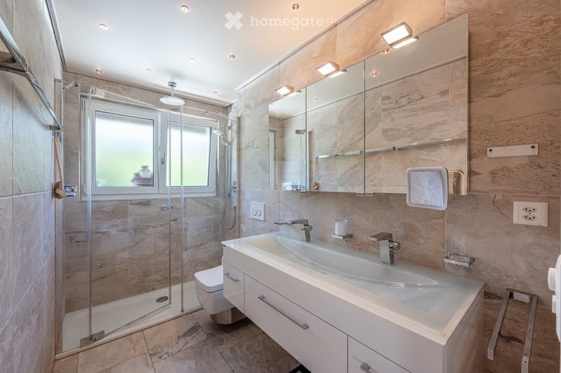 modern bathroom with shower, toilet, sink, mirror, and tiled flooring