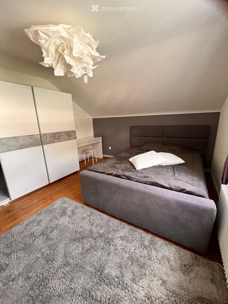 bedroom with bed, wardrobe, desk, stool, carpet, radiator