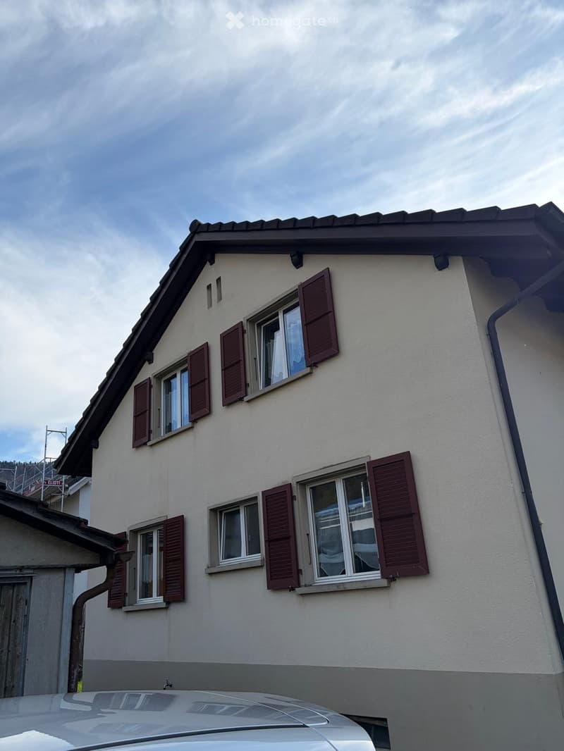 2 story house, beige walls, brown shutters, 6 windows