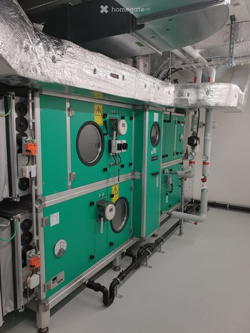 Industrial equipment with green cabinets, pipes, and gauges