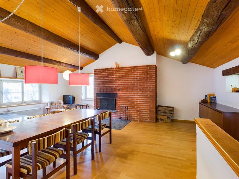 dining room with wooden table, chairs, fireplace, brick wall, wooden ceiling, windows
