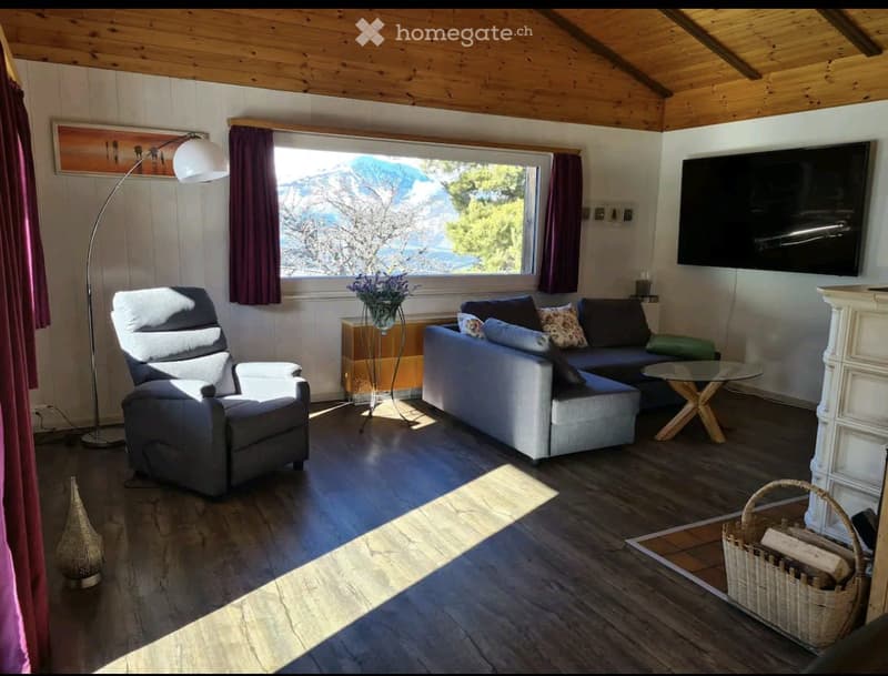 wooden floor, fireplace, large window, sofa, armchair, coffee table, TV, floor lamp, basket