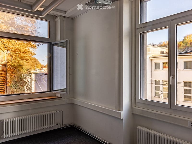 empty room, white walls, large windows, radiators, black floor
