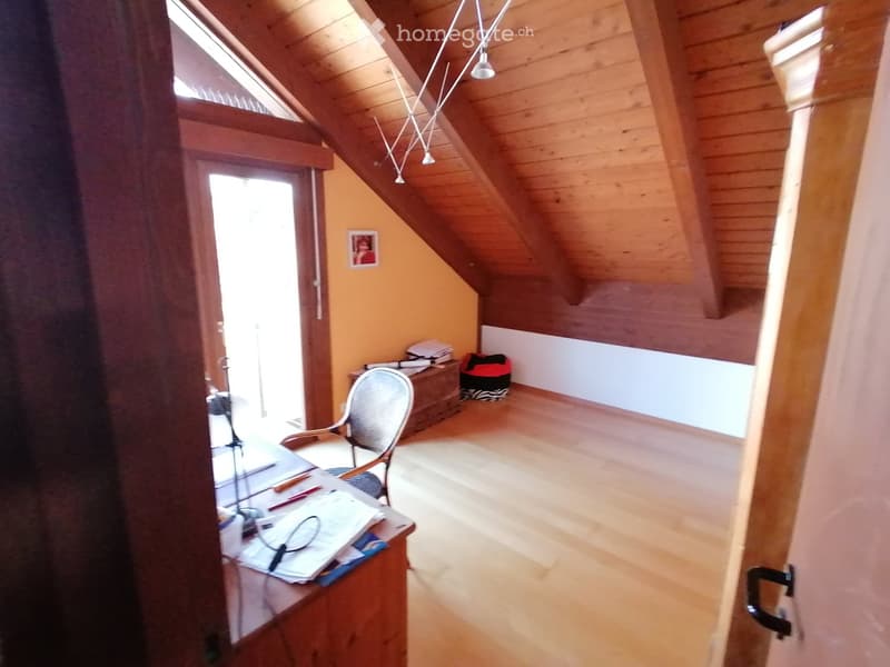 wooden floor, wooden ceiling, desk, chair, picture frame, books, pen, pencil, lamp