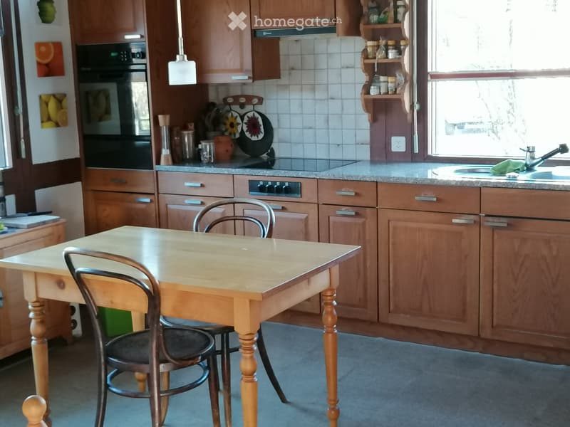 wooden cabinets, wooden table, chairs, oven, stove, sink, countertop, shelves, window