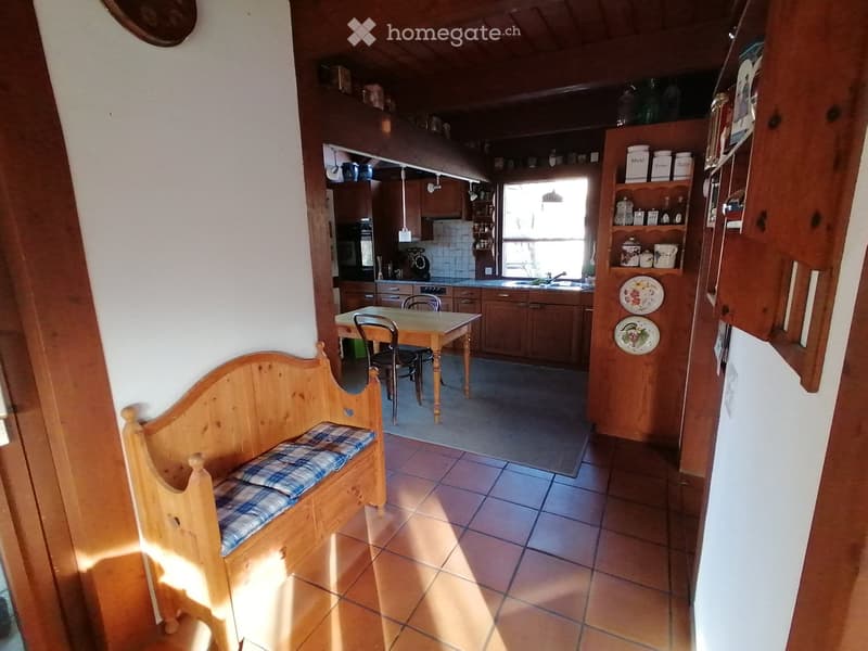 kitchen with dining area, wooden bench, wooden table, chairs, wooden cabinets, tiled floor, window