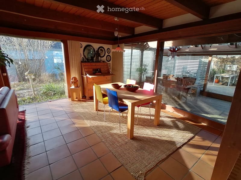 dining room with wooden table, chairs, rug, wooden cabinet, glass windows, wooden ceiling