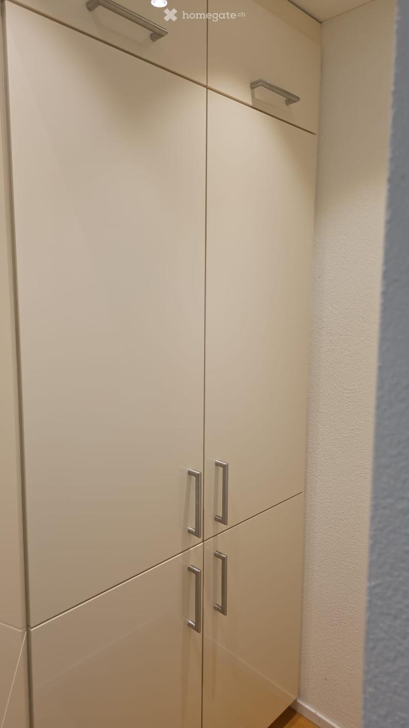 white cabinets, silver handles, wooden floor