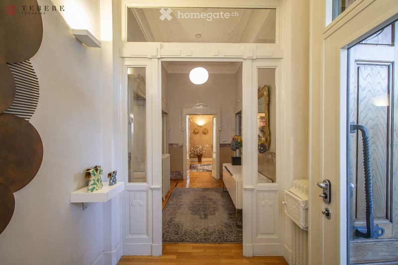 white walls, wooden floor, hallway, rug, white doors, white shelves, decorative items, mirror, radiator