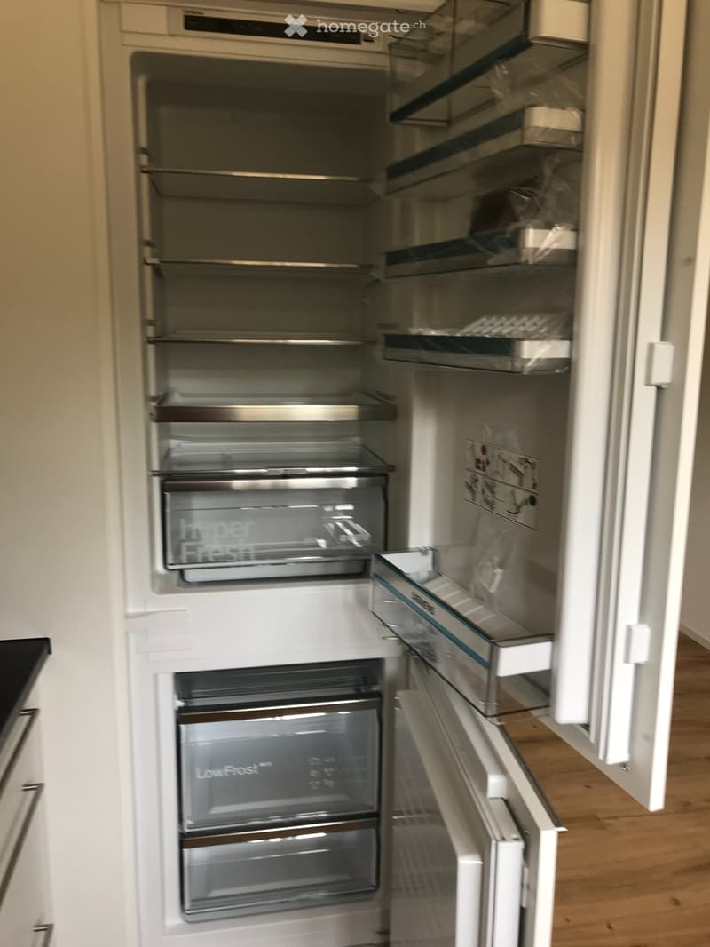 Open refrigerator with glass shelves, LowFrost technology, hyperFresh compartment, drawers, and a small compartment