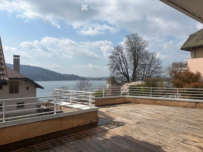 wooden deck, white railings, view of the lake and mountains