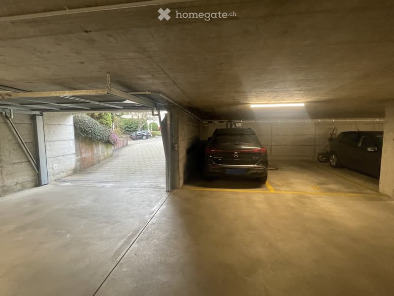 {"visible_features": ["Parking place"], "type": "Parking place", "objects": ["car", "motorcycle"], "description": "An underground parking space with a car parked inside and a motorcycle parked on the side.", "localized_descriptions": {"EN": "An undergroun