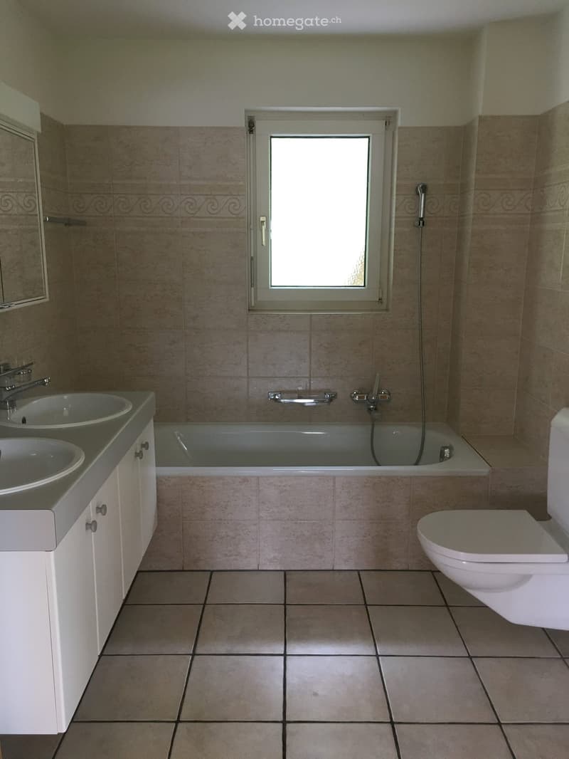 Bathroom with two sinks, bathtub, shower, and toilet.