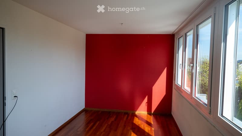 empty room, red wall, wooden floor, white walls, windows