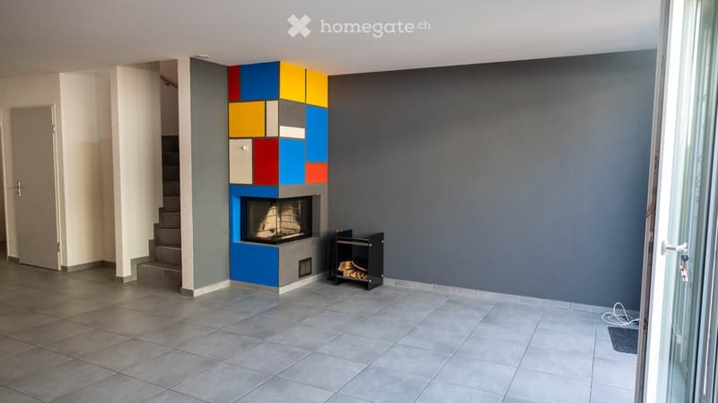 Fireplace with modern design, tiled floor, gray walls, staircase