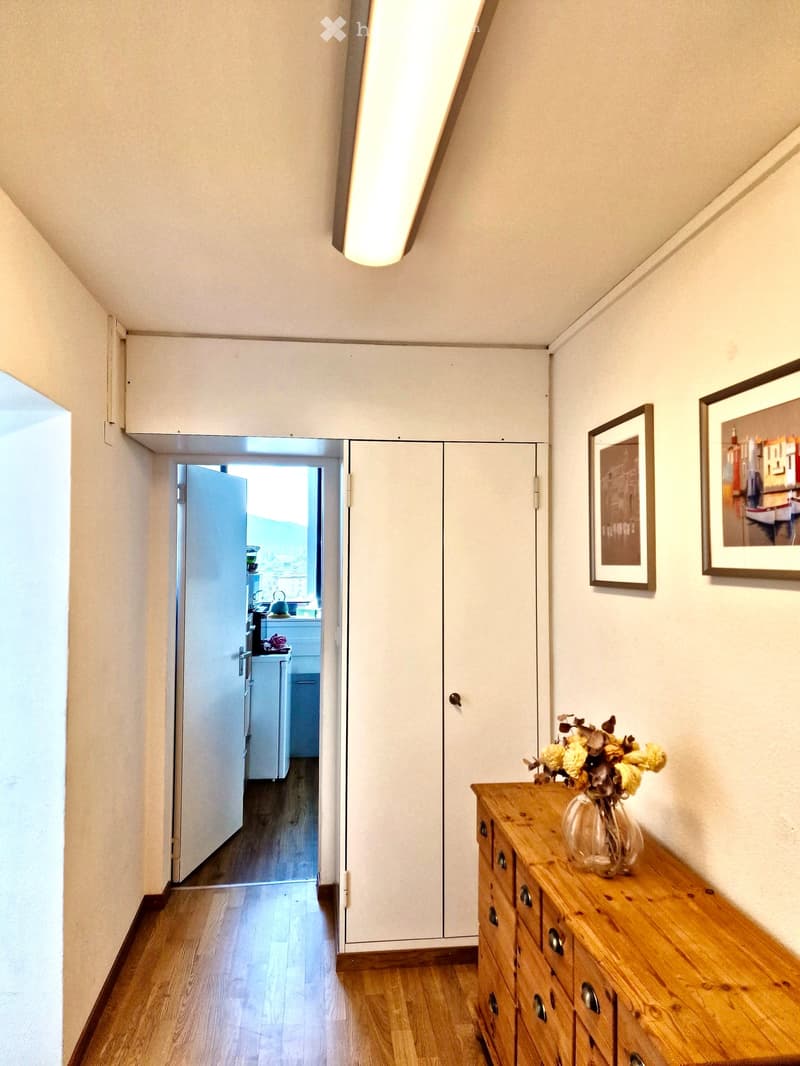 wooden floor, white walls, open door, white wardrobe, wooden cabinet, flower vase, picture frames