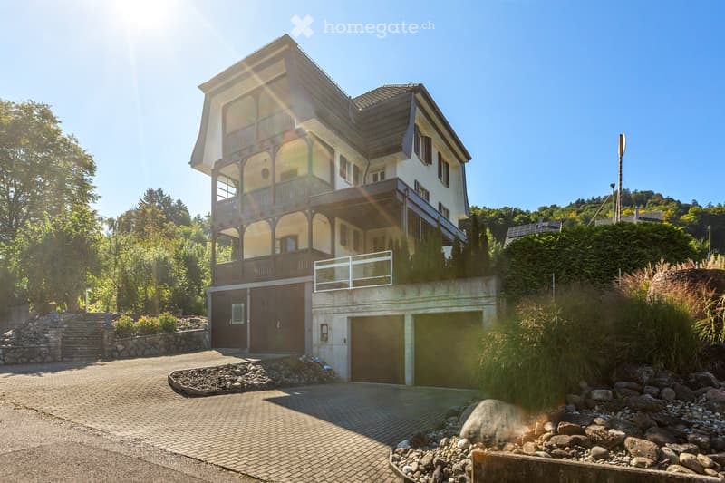2 story house, brown and white, 2 garages, driveway, balcony, garden