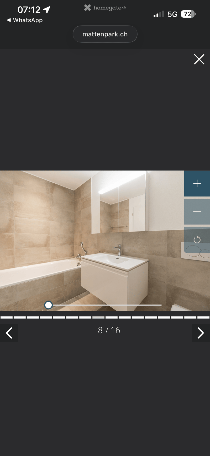 Bathroom with bathtub, sink, mirror, and tiled walls
