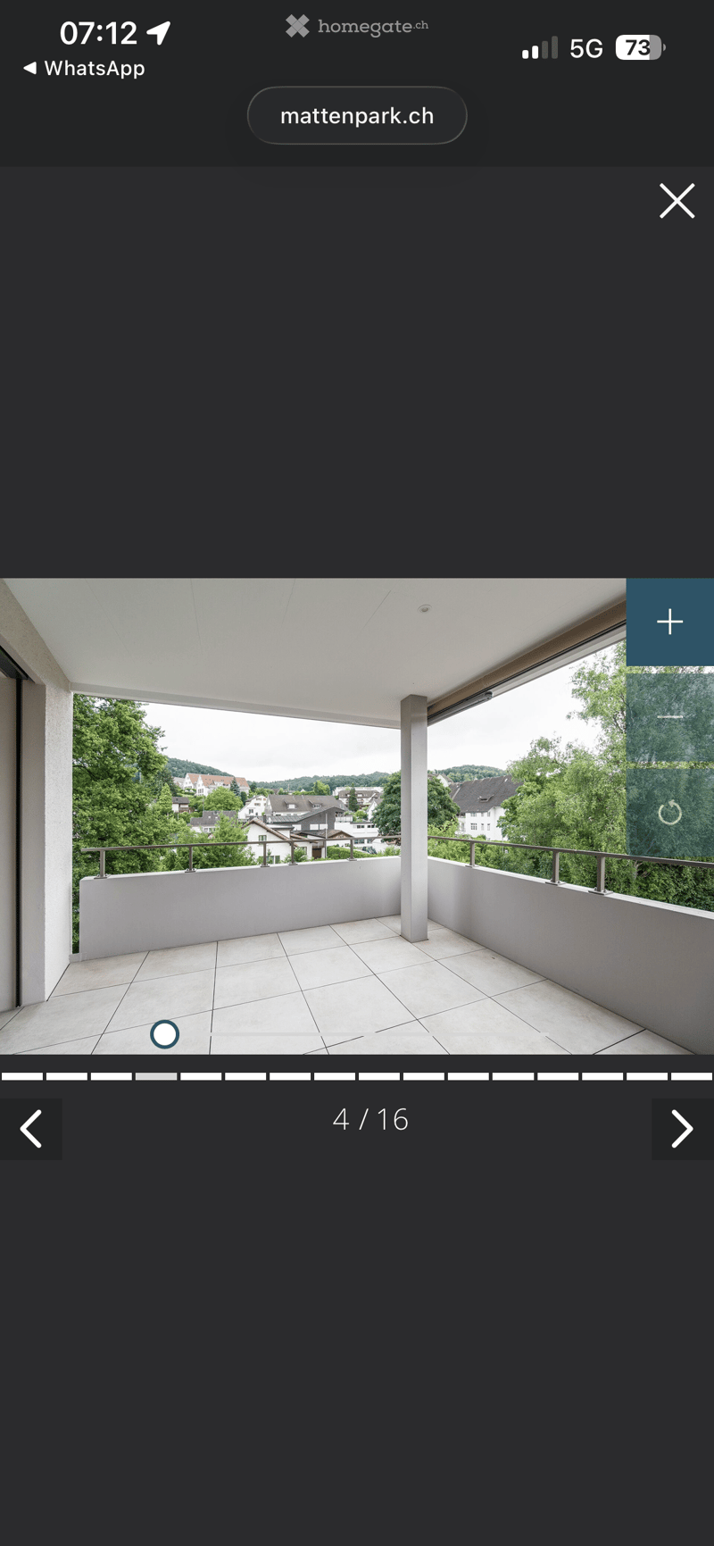 Balcony with tiled floor, metal railings, and a view of the city