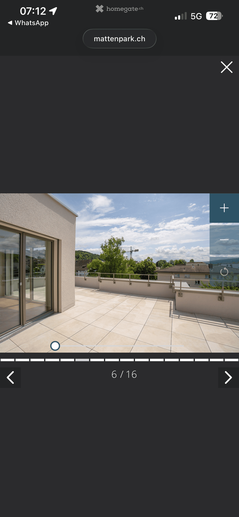 Terrace with tiled floor, glass doors, metal railings, and a view of the surrounding area
