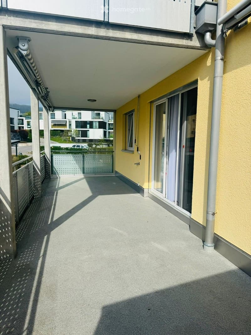 Balcony with metal railing, yellow wall, glass door, sliding glass door, metal fence