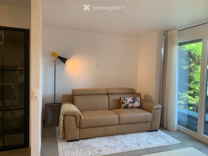 Leather couch, rug, lamp, sliding glass door, balcony