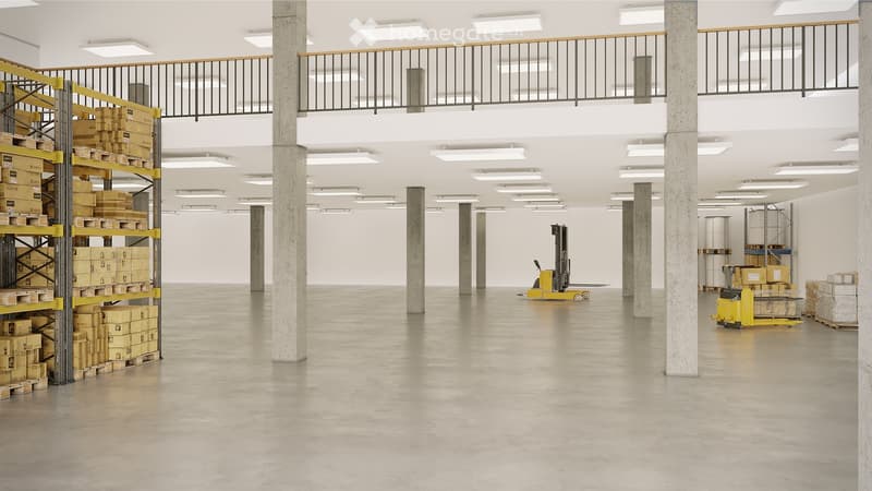Spacious warehouse with concrete pillars, empty space, storage shelves, balcony, ceiling lights, and forklifts.