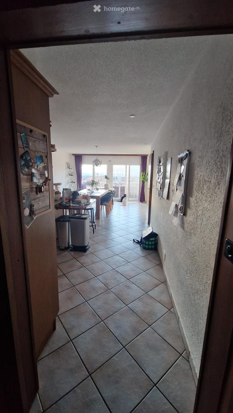 tiled floor, dining table, chairs, trash bins, potted plants, hallway, wall decorations