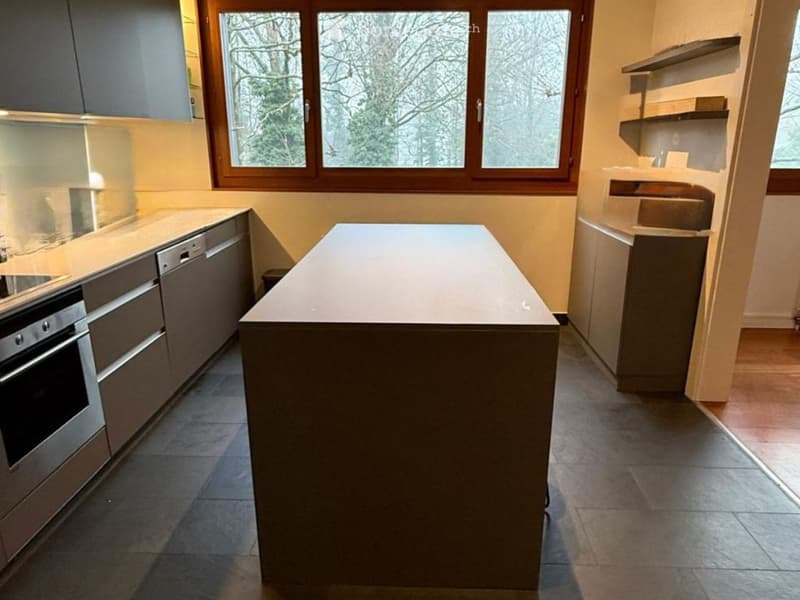 modern kitchen with island, large window, stainless steel appliances, tiled floor