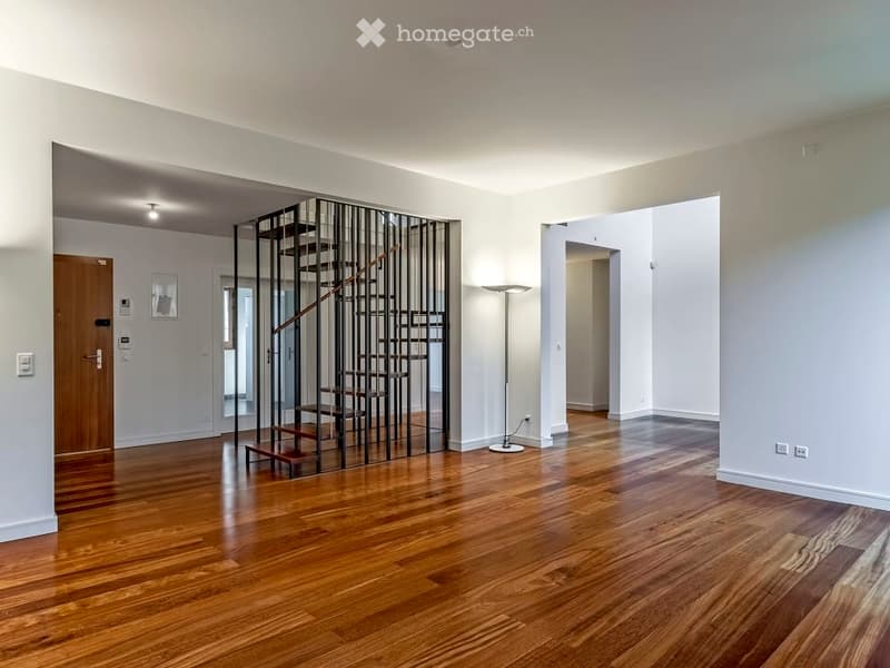 empty room, wooden floor, white walls, spiral staircase, floor lamp, power outlets