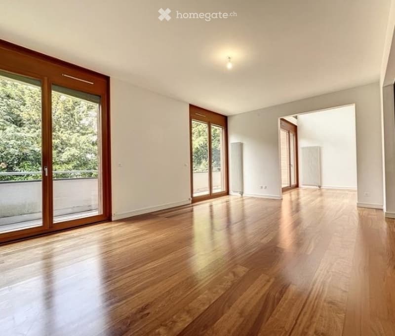 large room, hardwood floors, sliding glass doors, balcony, white walls, ceiling light