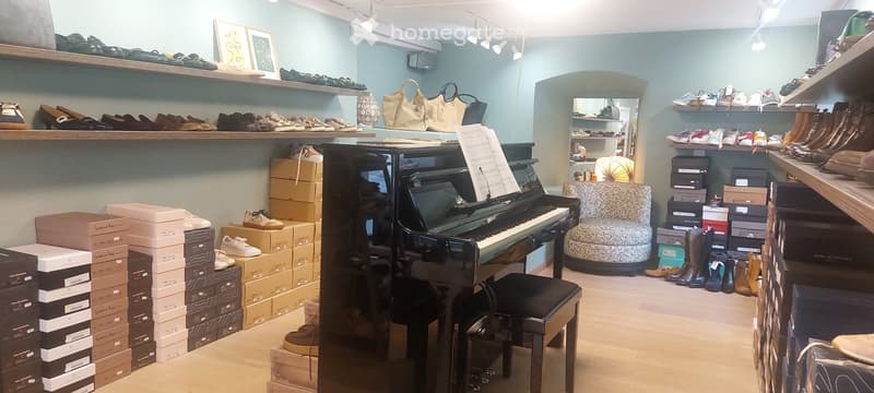 Piano, chair, shelves with shoes, boxes, lamps